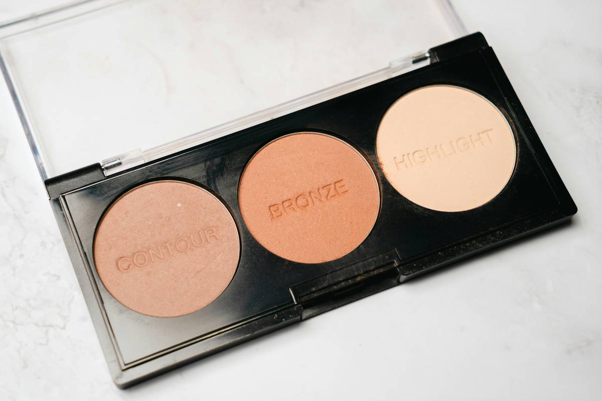 Model using glow-enhancing palette on highlighted facial zones for natural radiance