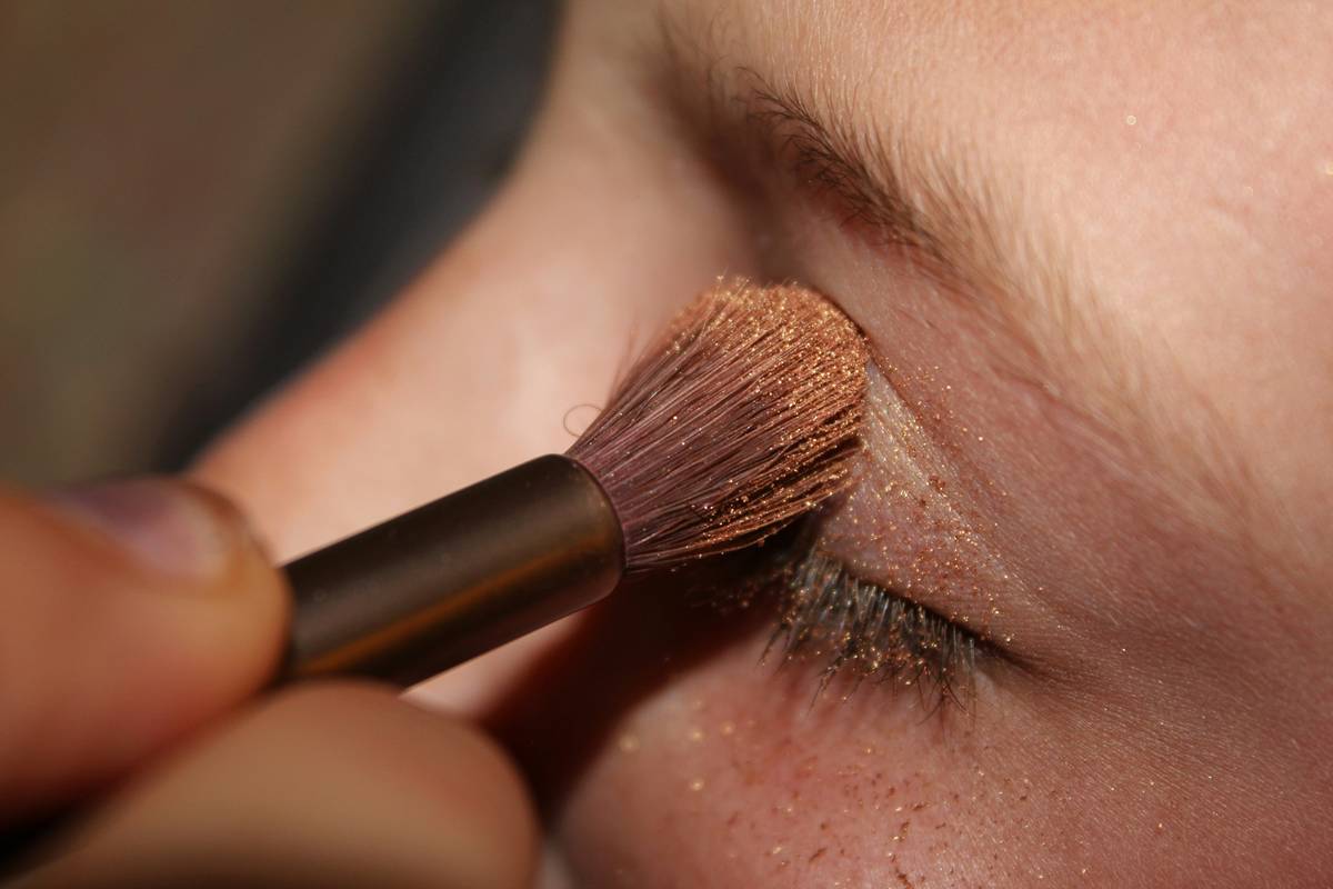 Close-up of model wearing bold metallic eyeshadow on eyelids with soft blended edges